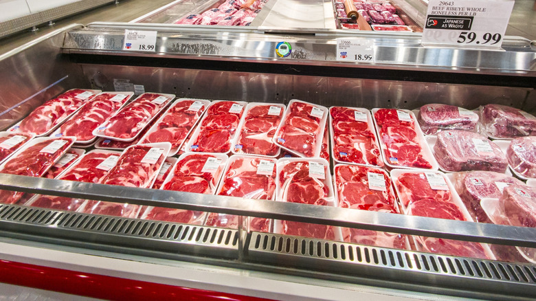 Cooler case full of fresh packaged steaks inside Costco store