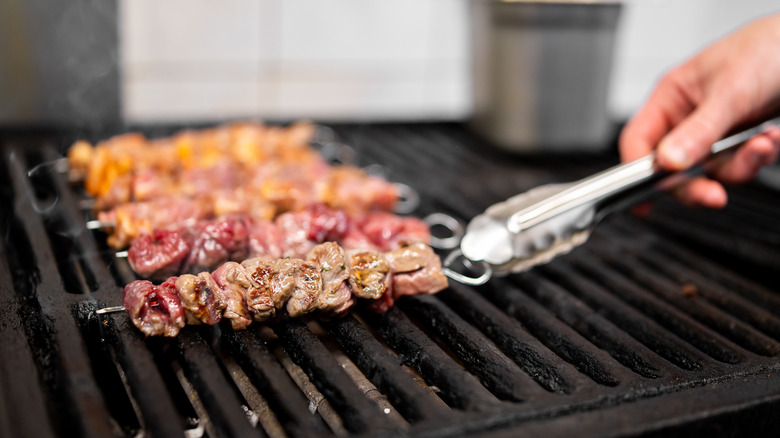 Grill with meat on kabobs