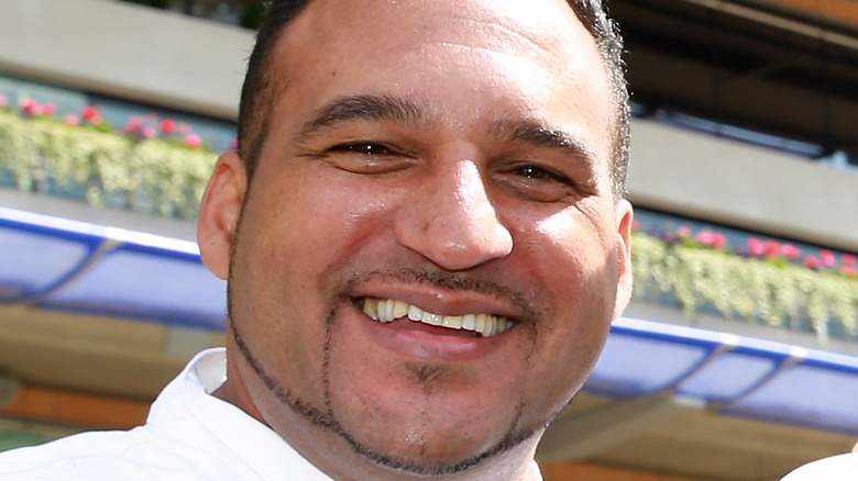 Chef Michael Caines smiles in white shirt