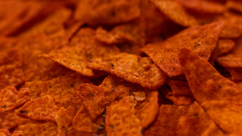 A foregrounded, closeup of orange Doritos