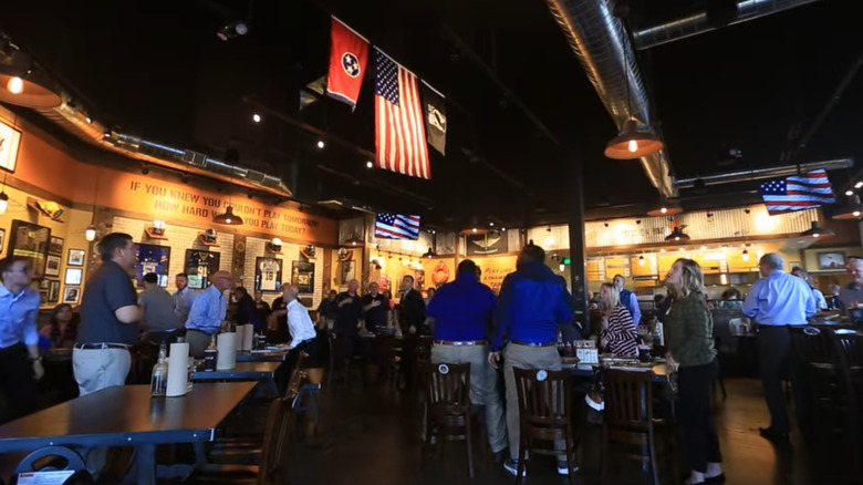Guests at Mission BBQ standing for the noon National Anthem