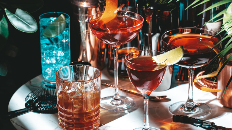 Several alcoholic cocktails, each served in a different glass