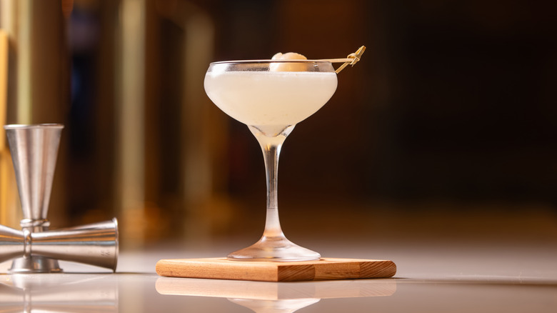 A lone off-white cocktail in a stemmed glass