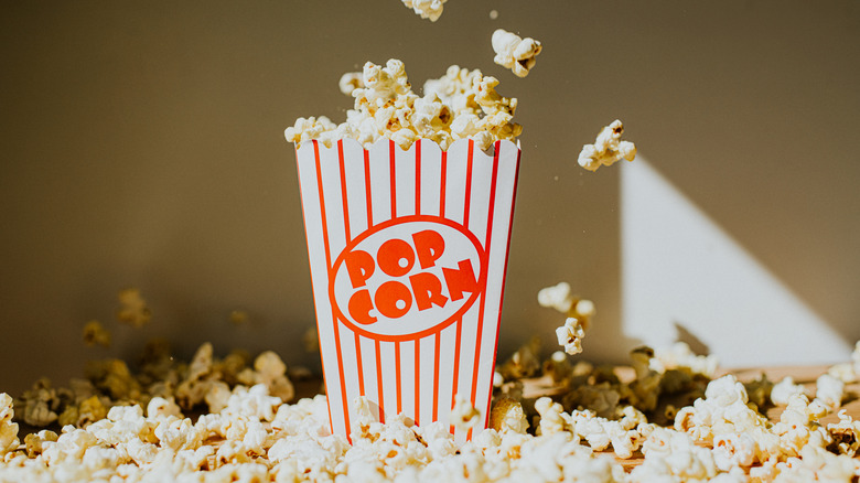 Box of popcorn surrounded by popcorn