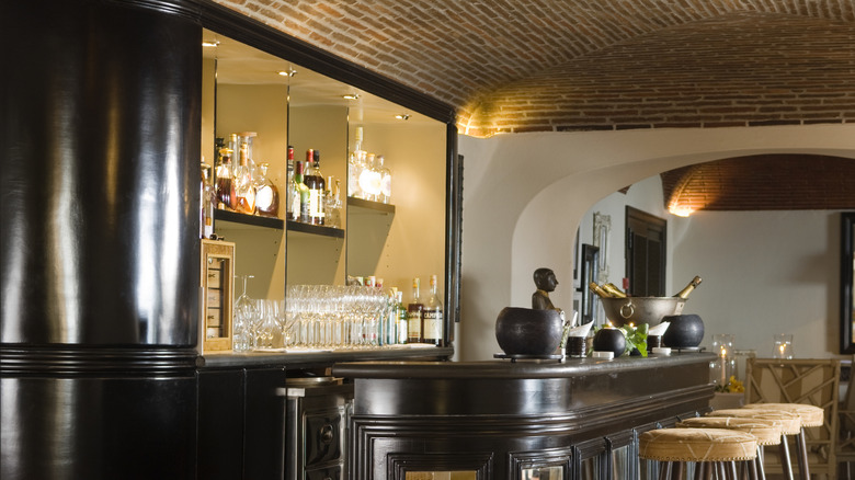 liquor bottles on shelf in home bar