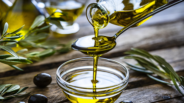 pouring olive oil on spoon