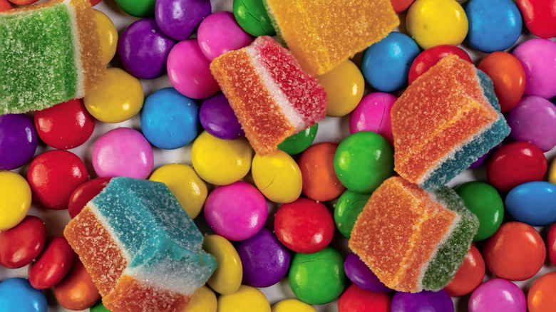 Close-up overhead shot of gummy candies and colorful chocolate candies, popular in the 1990s