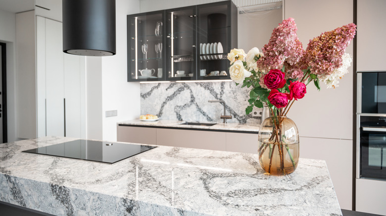 Kitchen with a dramatic stone countertop and backsplash