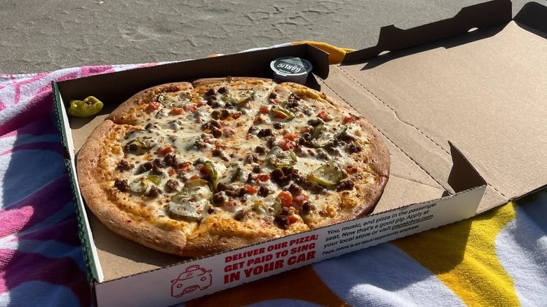 Papa Johns pizza in box with pepper
