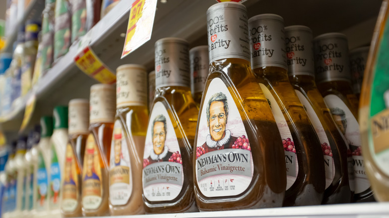Newman's Own salad dressing bottles on a grocery store shelf