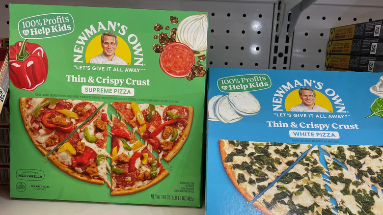 Newman's Own frozen pizzas in a grocery store freezer