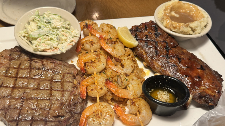 steak, ribs, and chrimp skewers on a plate
