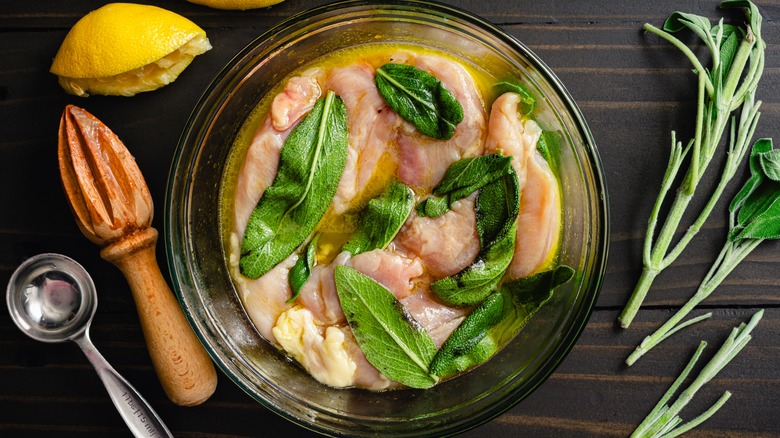 chicken in citrus marinade with green leaves