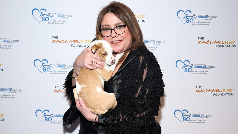 Rachael Ray holding a puppy at an event for The Rachael Ray Foundation