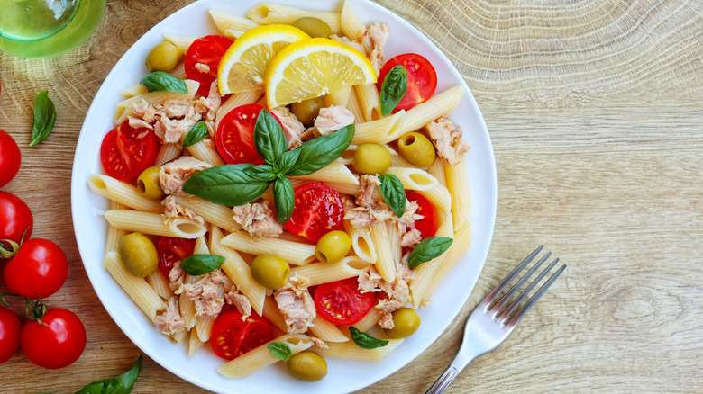 plate of tuna pasta with cherry tomatoes and olives