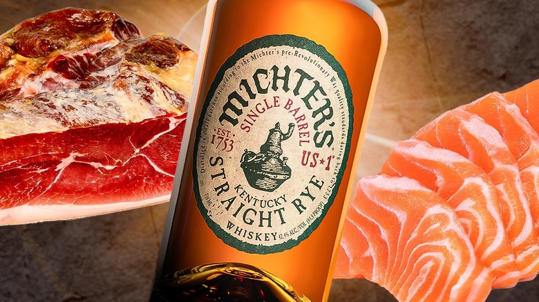 A bottle of Michter's rye whiskey with steak and salmon