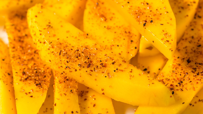 Slice of mango sprinkled with chili salt