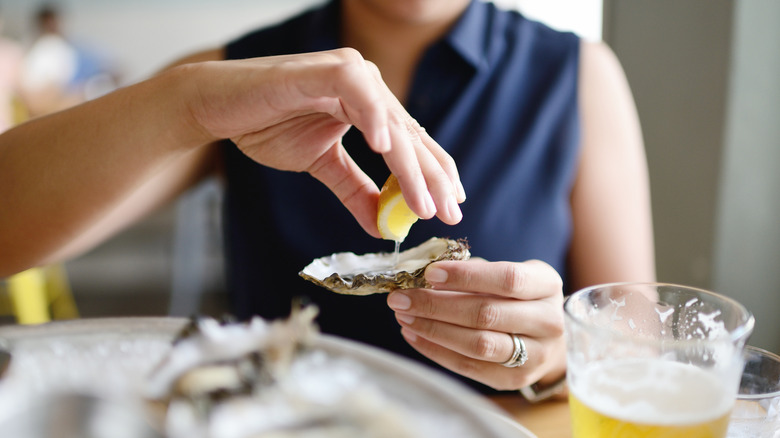 eating oyster with lemon