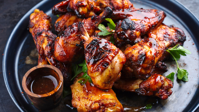 Marinated chicken on black plate