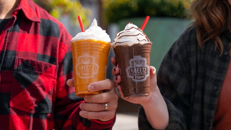 people holding Sheetz milkshakes