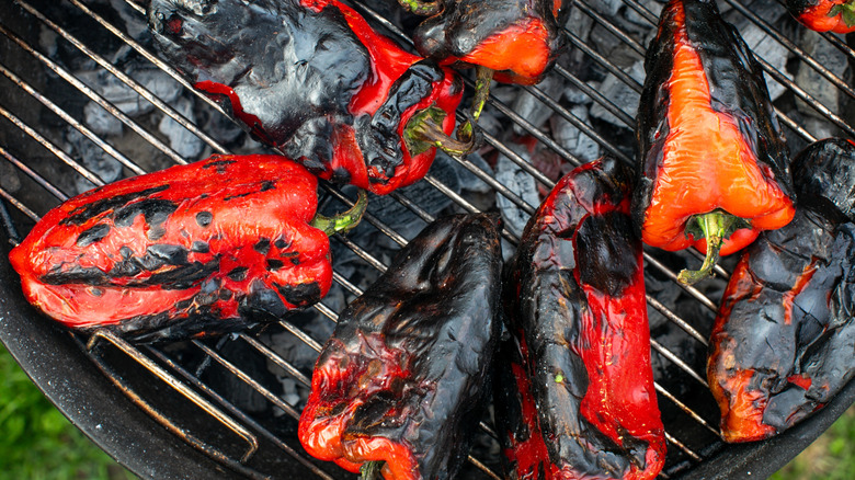 Charred peppers on a grill
