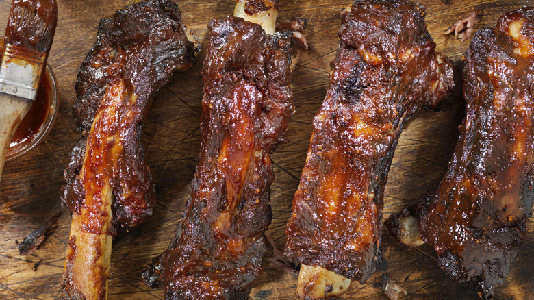 Four barbecue ribs with sauce painted on