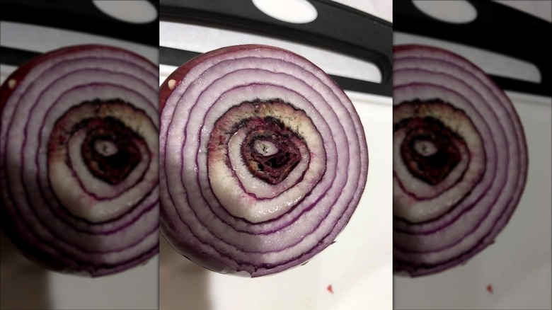 Close up of cut up Aldi red onion with black spots at the center