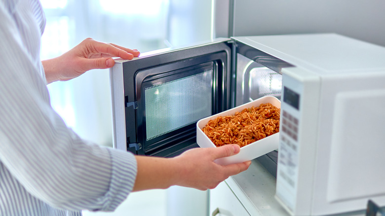 putting food into the microwave