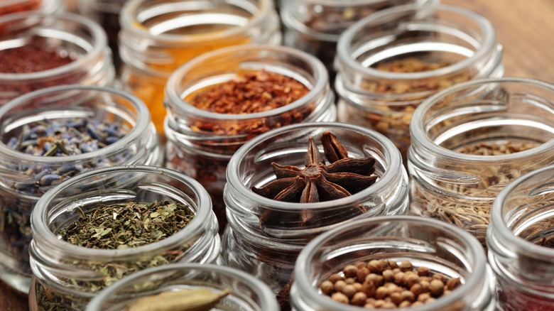 Open jars of various whole spices