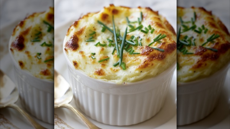 Ramekin of savory soufflé garnished with fresh chives