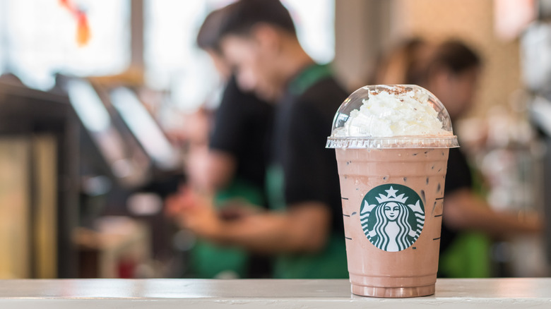 Starbucks drink with employee behind