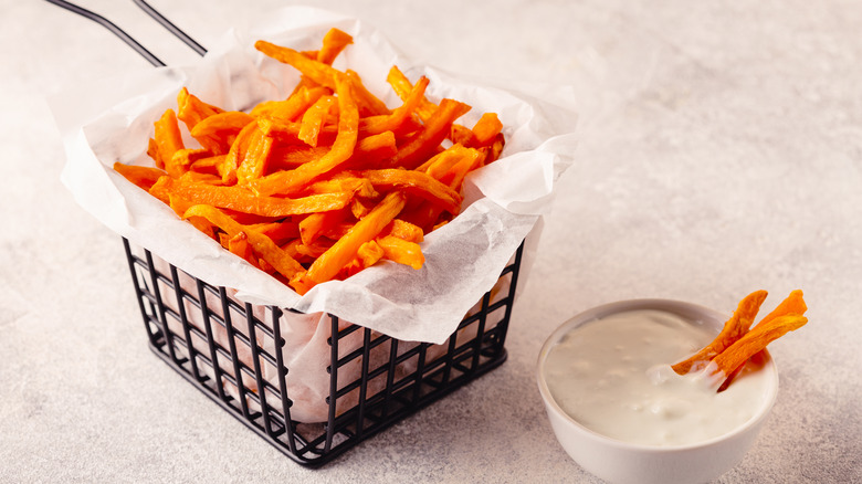 basket of sweet potato fries with dipping sauce