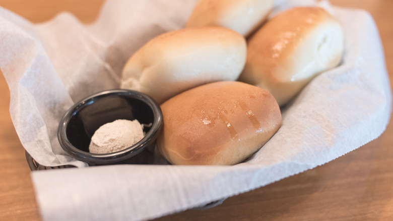 Texas Roadhouse roll basket with container of honey cinnamon butter