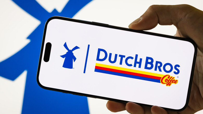 Someone holding a phone with Dutch Bros coffee pulled up on screen