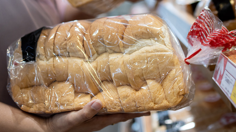 Person holding sliced bread loaves