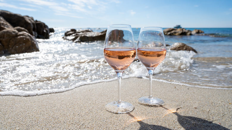 Glasses of rose on beach