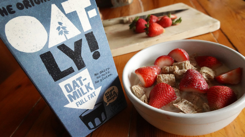 Oatly milk carton with bowl of cereal