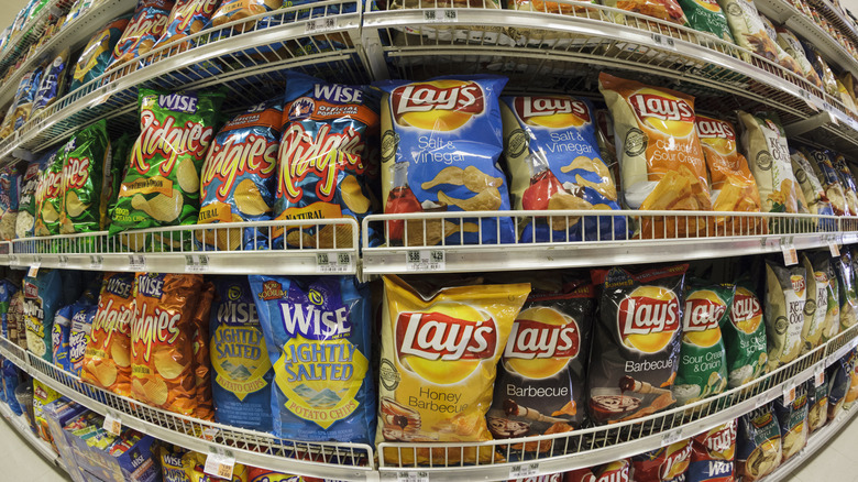A fisheye photo of potato chip bags on supermarket shelves