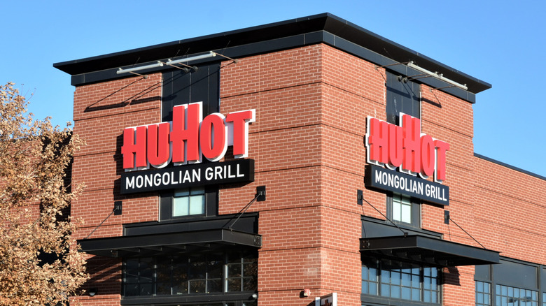 HuHot Mongolian Grill restaurant with red sign and brown brick exterior