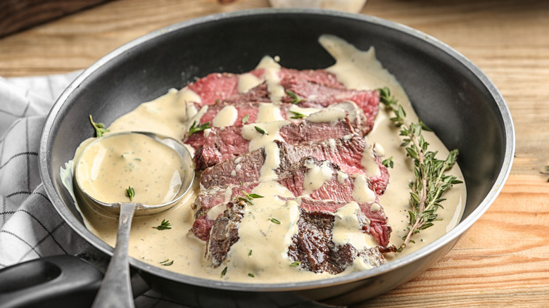 A pan of steak Diane