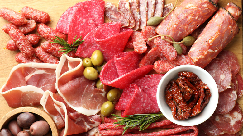 a charcuterie board filled with cured meats
