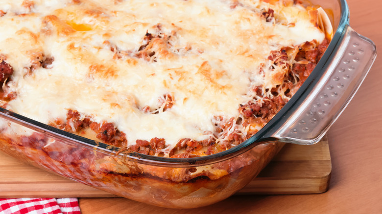 Baked cheesy lasagna in glass casserole dish