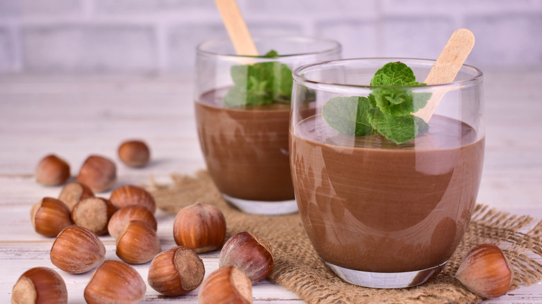 bowls of chocolate pudding with hazelnuts