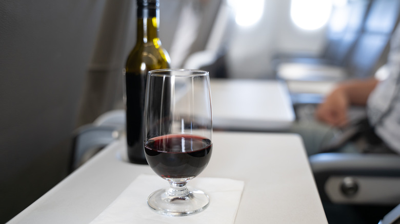 wine and bottle on airplane tray
