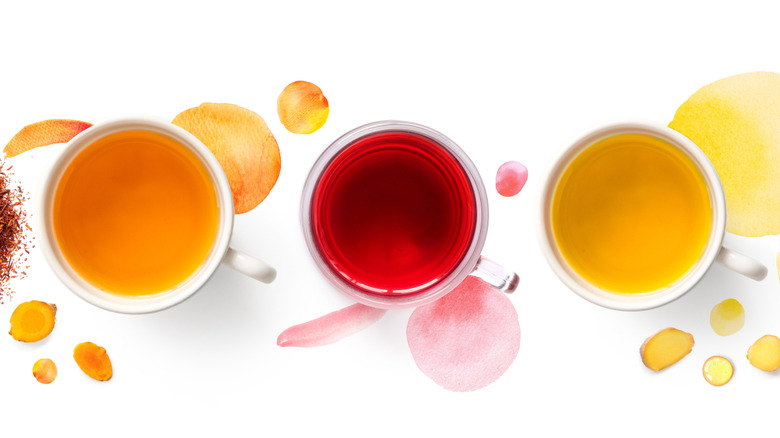 Mugs of naturally colored water, from above