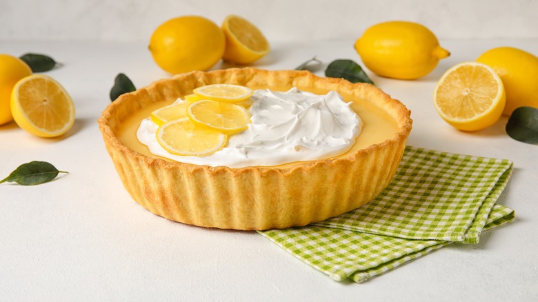 lemon tart surrounded by lemons