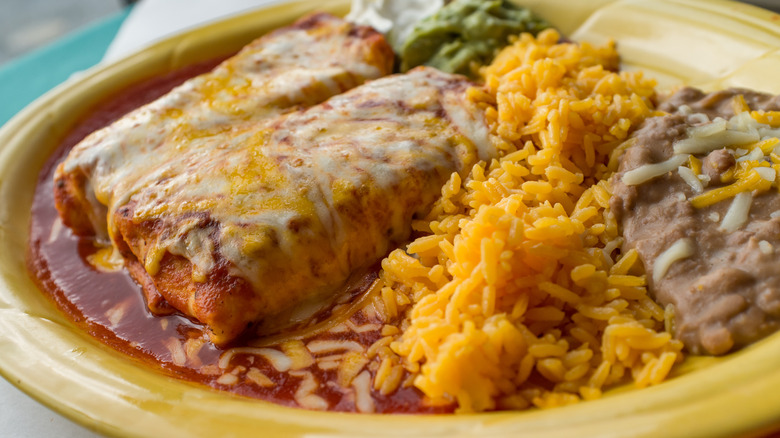 Chimichanga smothered in cheese and sauce