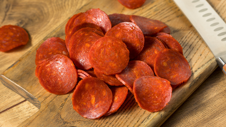 pepperoni slices on wooden board