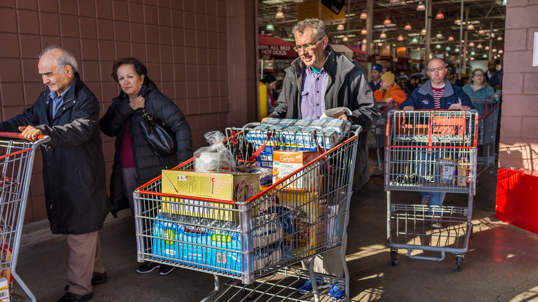 shoppers leaving Costco with carts