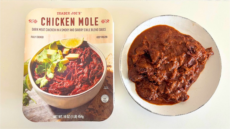 A white bowl of shredded chicken and sauce